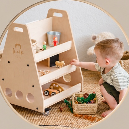 A child independently reaching for toys on a Luula shelf